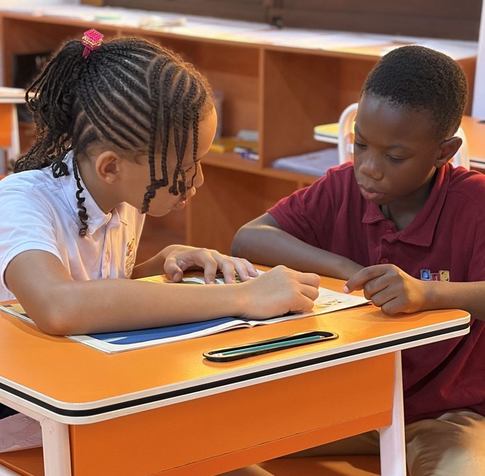Two BrightSteps students working together at a desk
